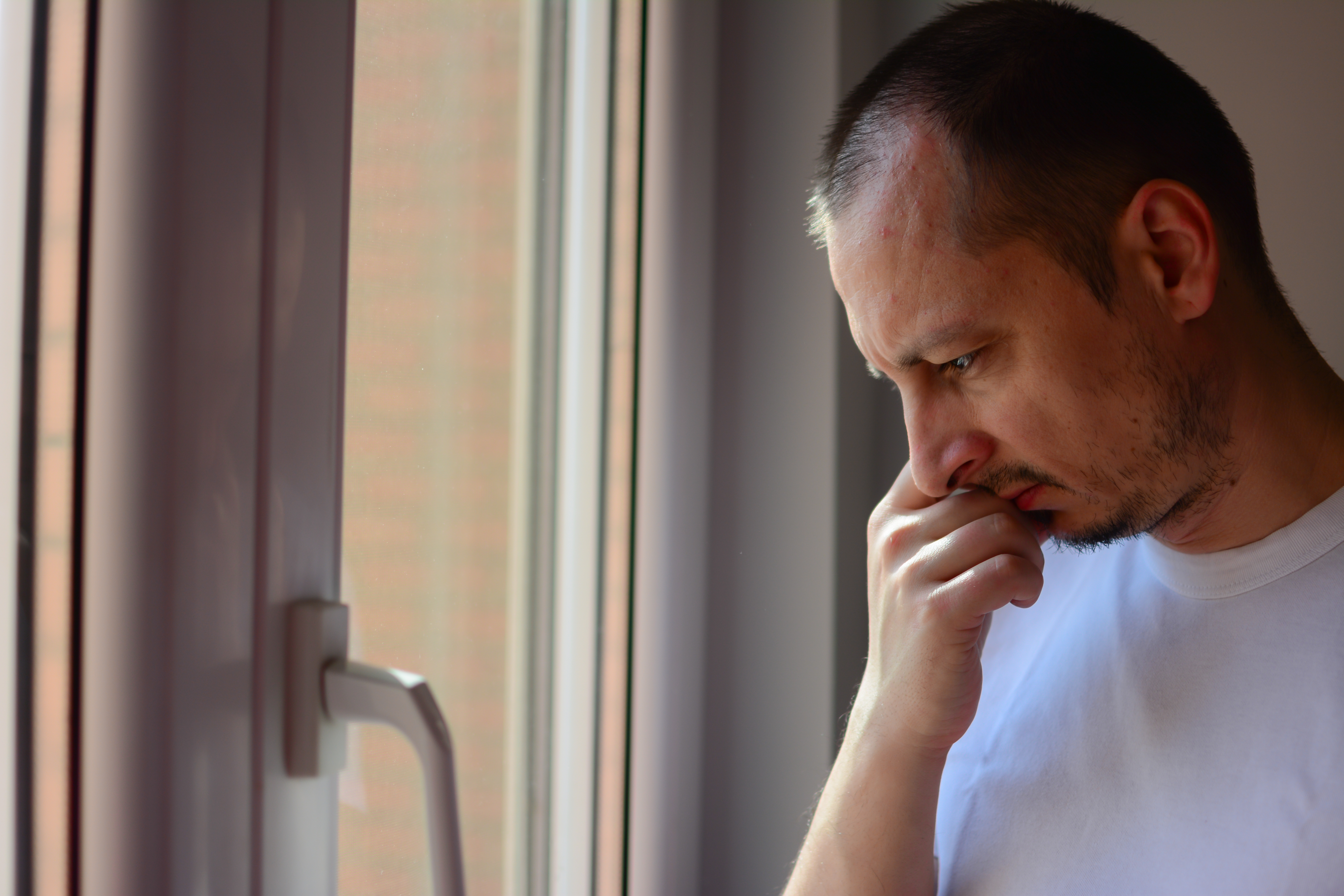 Man looking out window